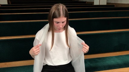 Wall Mural - Young religious devoted woman praying in baptist church. Faithful catholic at european cathedral: inside of holy place