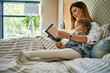 © Westend61 - Mother and daughter reading a book in bed