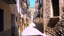 Charming Little Narrow Street In An Old Spanish Village, With No People In Sight During The Bright Sunny Summer Day, 4k Top Down View
