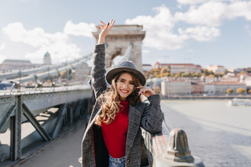 Wall Mural - lovable female tourist in elegant attire expressing happy emotions. charming white woman in tweed co