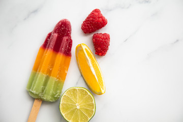 Wall Mural - Summer fruit ice lollies made with orange lime and raspberries