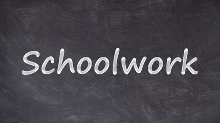 Schoolwork text written on blackboard