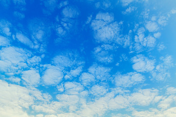 Fluffy white clouds flying on blue sky background