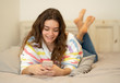 © SB Arts Media - Portrait of young beautiful girl texting and chatting on her sma