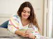 © SB Arts Media - Portrait of young beautiful girl texting and chatting on her sma