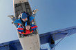 Tandem skydiving. Man and woman are in the sky.