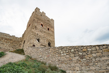 Ancient fortress on a mountain with green southern grass