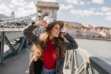 Wall Mural - gorgeous young woman posing with excitement during travel in europe. outdoor portrait of long-haired