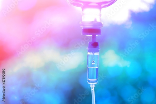 Saline iv bag intravenous drip hospital room,Medical Concept,treatment patient emergency and injection drug infusion care chemotherapy concept.blue light background hospital,Selective focus