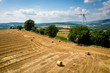 © Stephen Davies - Aerial view of Straw bales with a wind turbine on farmland in Wales UK