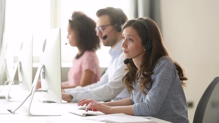 Wall Mural - young woman customer care agent in headset consulting online client