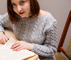 Wall Mural - Young woman reading a book at home