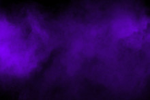 Freeze Motion Explosion Of Purple Powder Dust On A Black Background. By Throwing Blue Talcum  Out Of Hand. Stopping The Movement Of Purple Powder On Dark Background.