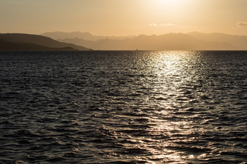 A beautiful sunset occurs in Komodo National Park, Indonesia. This remote region, part of the Coral Triangle, has high marine biodiversity and is a popular destination for divers and snorkelers.