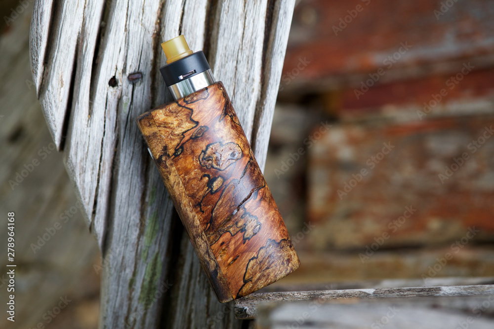 wood box mod high end natural stabilized wood box mods with rebuildable dripping  atomizer, vaping device, selective focus Stock Photo