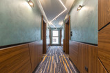 Fototapeta  - Hotel interior carpeted corridor hallway