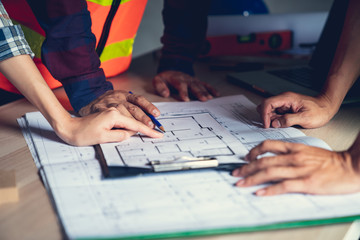 Architect & Engineer working drawing document about project planning and progress of work schedule on the home building construction site , Drawing docement is make new for stock NOT COPYRIGHT