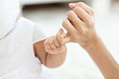 © 220 Selfmade studio - Close up hand of baby be hand in hand of Mother feeling so comfortable and Safety,Happiness Love with Family Concept,Selective Focus