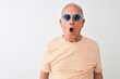 © Krakenimages.com - Senior grey-haired man wearing striped t-shirt and sunglasses over isolated white background afraid and shocked with surprise expression, fear and excited face.