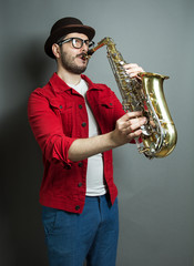 saxophone players on grey background. saxophonist jazz man with sax. music concept