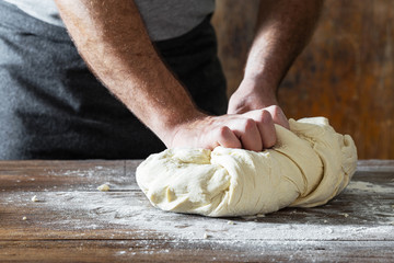 Canvas Print - Male hands knead the dough cooking homemade bread