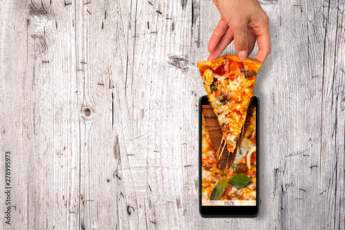 Order and food delivery from your smartphone. Smartphone on wooden background © Serge Touch