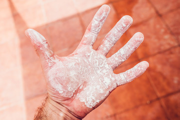 Man's palm soiled in white flour