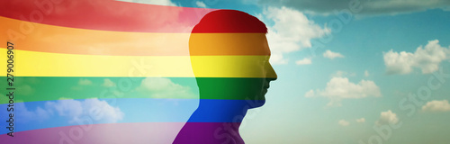 Silhouette of a man on the background of clouds and flag lgbt. Original conceptual idea on the subject of gender differences. Gay pride, LGBT, bisexual, homosexual concept.