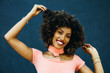 © Gerald Carter/Creative Flame - Smiling woman pulling on ends of her curly hair