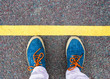 Women's feet in sneakers standing at the line.
