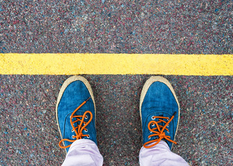 Women's feet in sneakers standing at the line.