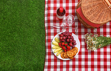Flat Lay Composition With Picnic Basket And Products On Checkered Blanket Outdoor, Space For Text