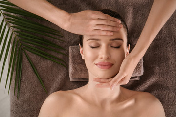 Wall Mural - Beautiful young woman enjoying massage in spa salon, top view