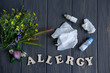 Conceptual photo with wildflowers, nose drops and shawls. Allergy. Allergy drops. Seasonal allergy to flower pollen