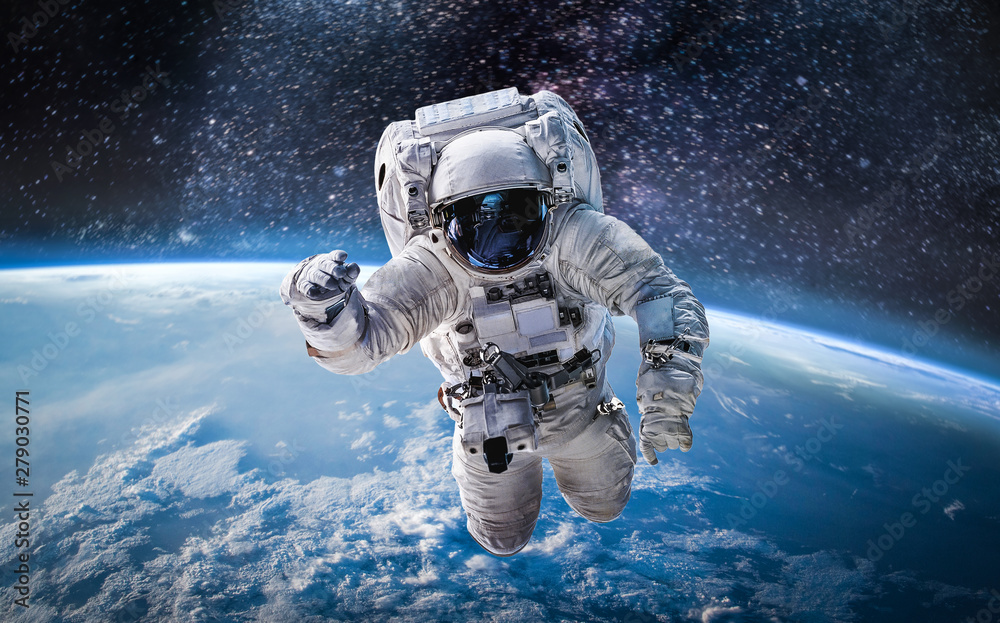 Astronauta w kosmosie nad planetą Ziemią - obrazy, fototapety, plakaty 
