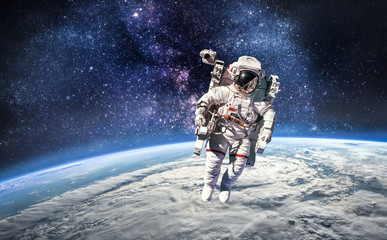 Leinwandbilder - Astronaut in the outer space over the planet Earth. Abstract wallpaper. Spaceman. Elements of this image furnished by NASA