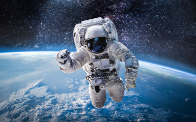 astronaut in the outer space over the planet earth. abstract wallpaper. spaceman. elements of this i