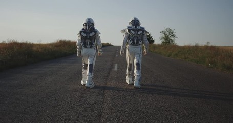 Wall Mural - Two astronauts walking on road