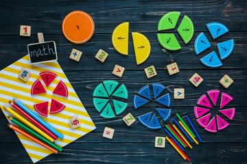 Wall Mural - Creative Сolorful math fractions on dark background. Interesting funny math for kids. Education, back to school concept. Geometry and mathematics materials. Flat lay, top view