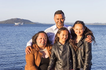 Portrait of a young Maori family taken outdoors