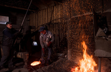 Wall Mural - blacksmith workers using mechanical hammer at workshop