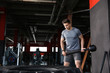 © Pixel-Shot - Sporty young man training with tire in gym
