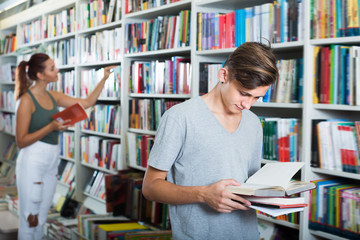 Wall Mural - Portrait of  teenager looking at open book