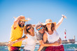 © simona - Group of happy people and cheerful adults friends have fun together during summer holiday vacation at the beach - enjoying the beach and ocean outdoor - blue sky and lighthouse in background