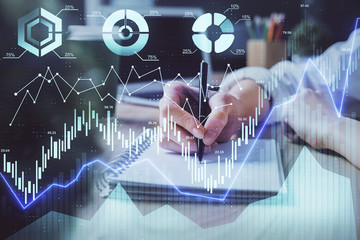 Forex chart displayed on woman's hand taking notes background. Concept of research. Double exposure