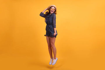 Full length body size view photo pretty lovely girl impressed astonished new sneakers shoes scream shout summer feel satisfied content rejoice dressed in modern clothing isolated yellow background