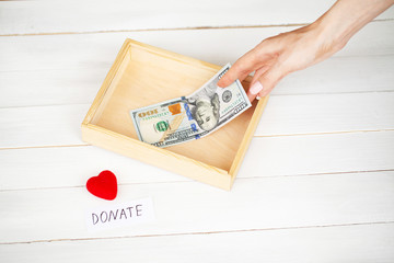 Donations and Charity. Donation Concept. Box of Donations and Heart on the White Background.