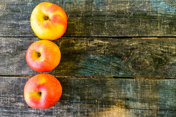 Pile of the ripe apples on wooden table. Top view