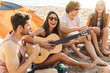 © Drobot Dean - Group of cheerful happy friends camping at the beach