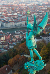 Statue of Saint Michel and the view over Lyon from basilique Notre-Dame de Fourvière, Lyon, France.